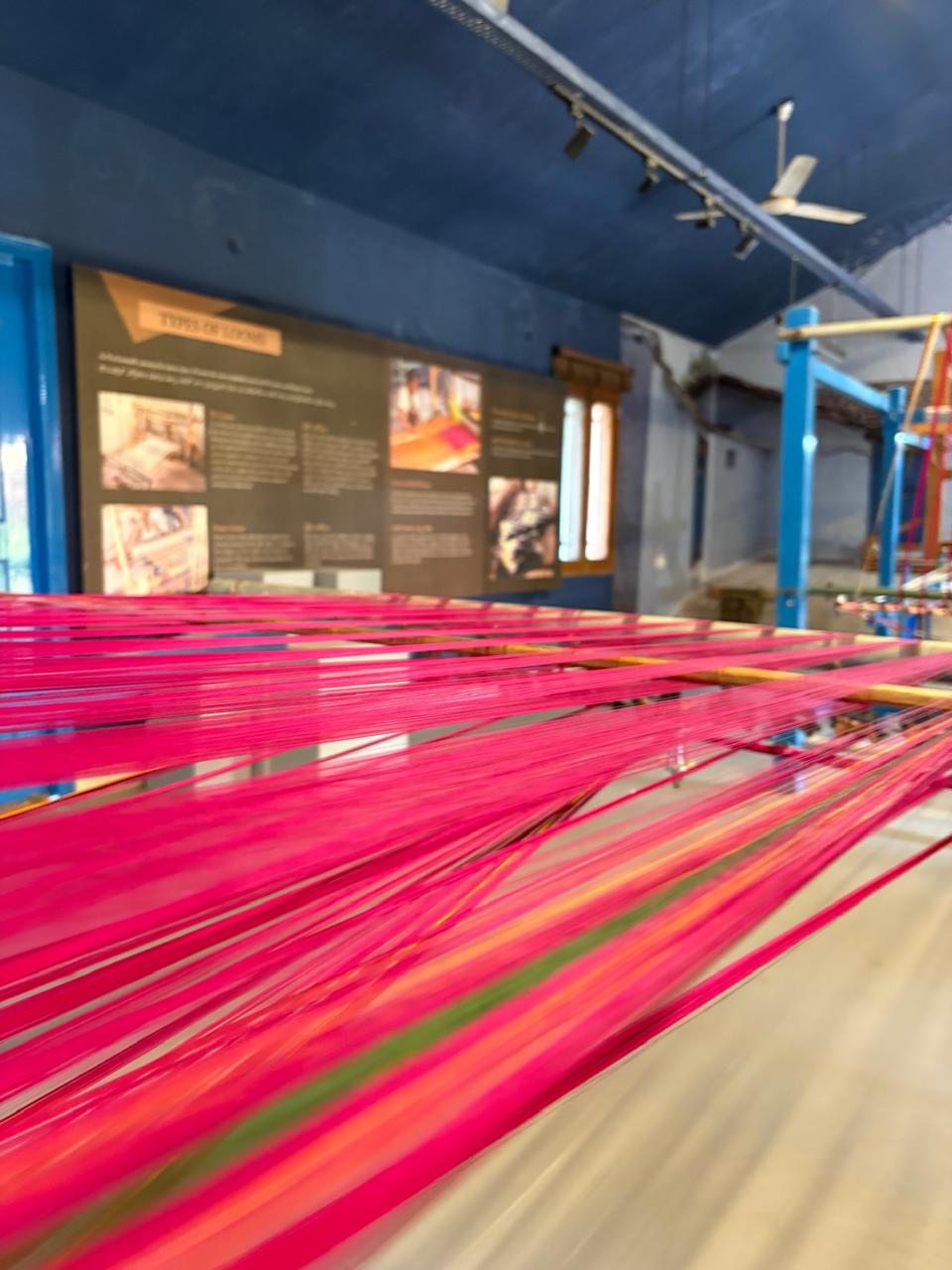 Pink silk warp on the loom